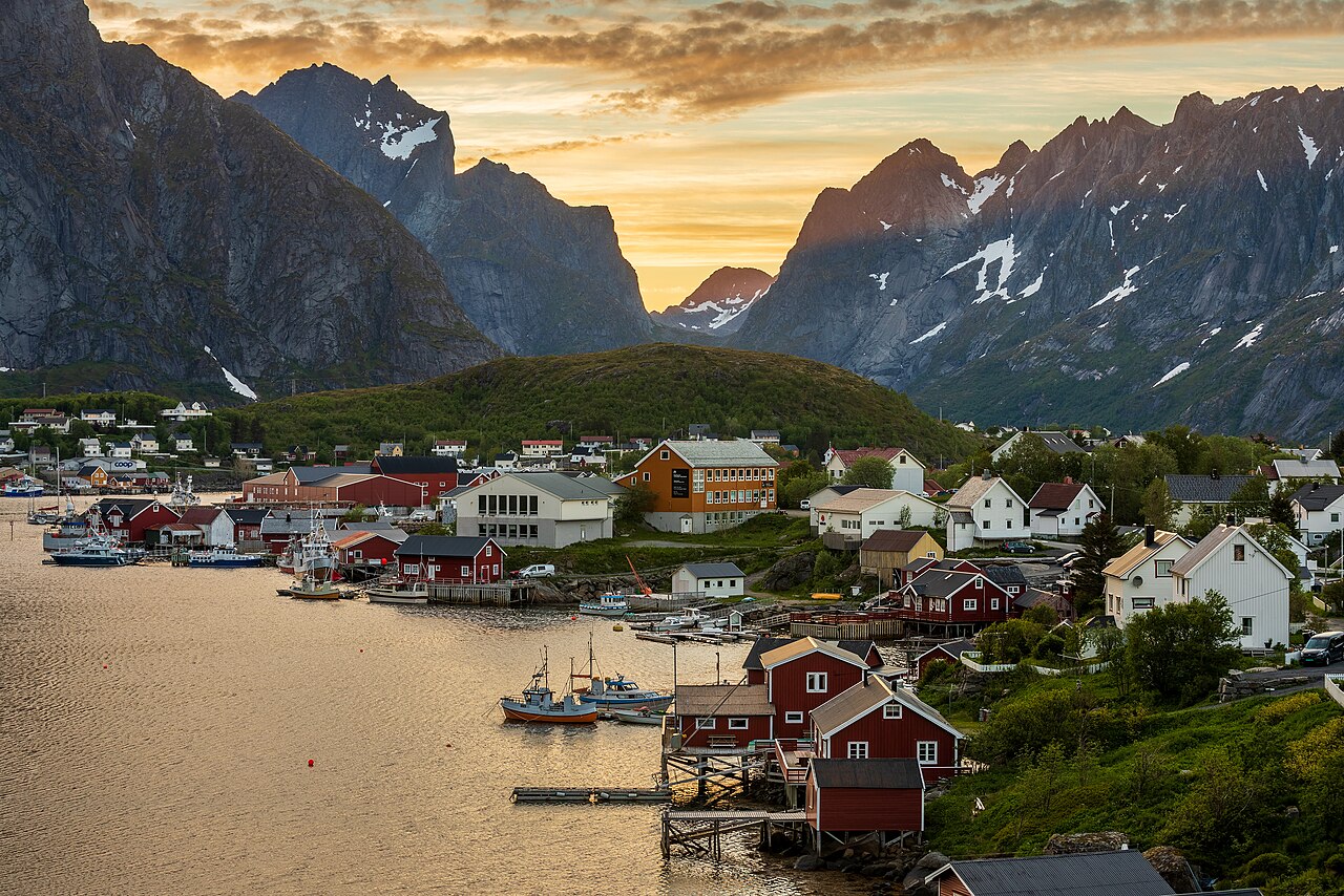 Vila de pescadores na Noruega sob um céu ainda claro em plena madrugada de verão, com o sol rasando o horizonte